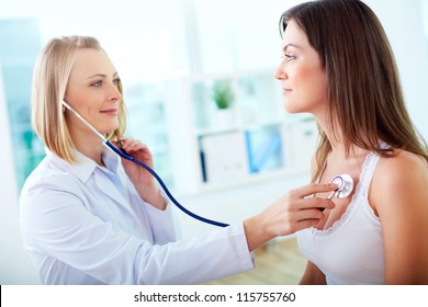 Portrait Of Confident Practitioner Checking Heart Beat Of Patient