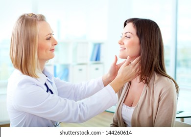 Portrait Of Confident Practitioner Examining Patient