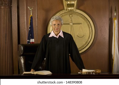 Portrait Of Confident Senior Female Judge Standing In Court Room