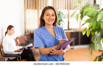 Portrait Of Confident Smiling Woman Medical Worker Standing In Clinic Office