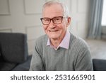 Portrait of confident stylish European middle aged senior man at home. Older mature 70s man smiling. Happy attractive senior grandfather looking camera close up face headshot portrait. Happy people