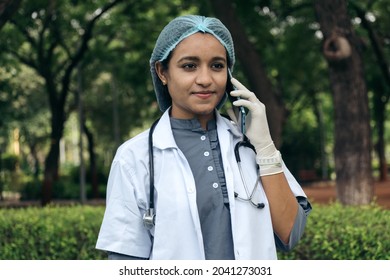 Portrait Of Confident And Successful Indian Female Doctor Talking On Phone. Concept On Treatment Of Patient Remotely On Phone Call Concept