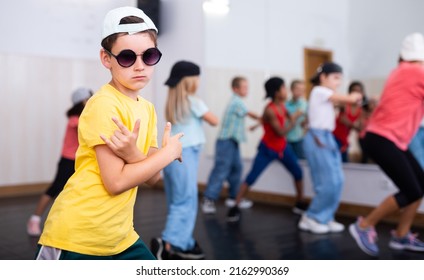 Portrait Of Confident Tween Boy Hip Hop Dancer Posing During Group Dance Class ..