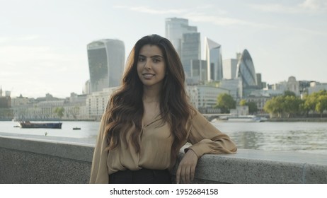 Portrait of confident young adult business woman in city of London looking at camera, independent female executive successful corporate career
