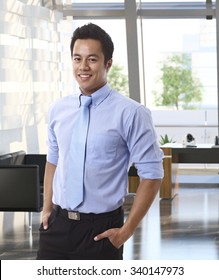 Portrait Of Confident Young Asian Businessman At Office.