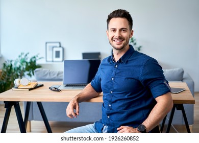 Portrait of confident young business man working at home