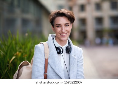 Portrait confident young business woman smiling in city success testimonial