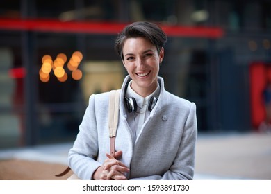 Portrait confident young business woman smiling in city success testimonial