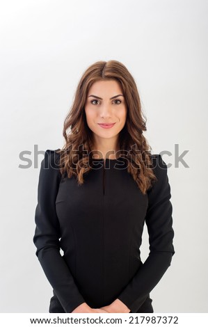 Portrait of a confident young business woman wearing black elegant dress and looking at camera!