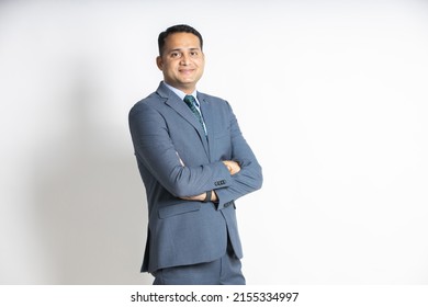 Portrait Of A Confident Young Indian Business Man In A Suit Standing With His Arms Cross, Isolated On White Studio Background. Successful Asian Male Ceo Of Company, Executive Manager. Blank Space.