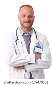 Portrait Of Confident Young Male Doctor Standing Arms Crossed, Smiling, Looking At Camera.