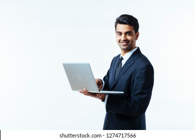 Portrait Of A Confident Young Man Entrepreneur In Business Suit Holding A Laptop And Smiling At Camera,  Isolated On White Background