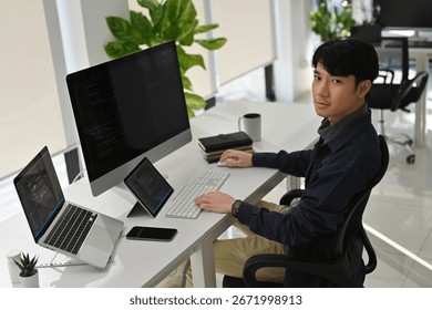 Portrait of a Confident Young Software Developer Working in a Modern Office.