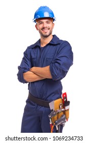 Portrait of a confident young worker standing with arms crossed on white background