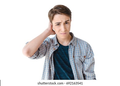 portrait of confused caucasian teenage boy looking at camera isolated on white