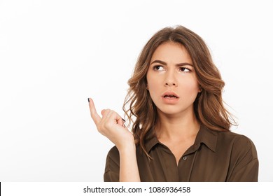 Portrait of a confused young woman looking away at copy space isolated over white background