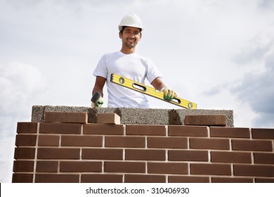 Portrait of construction bricklayer worker against sky.  