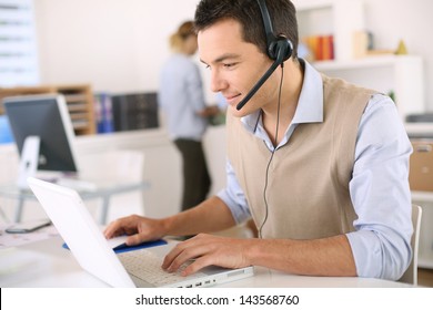 Portrait of consultant on the phone with headset - Powered by Shutterstock