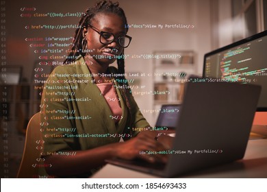 Portrait Of Contemporary African-American Woman Using Laptop With Computer Code Overlay, Copy Space