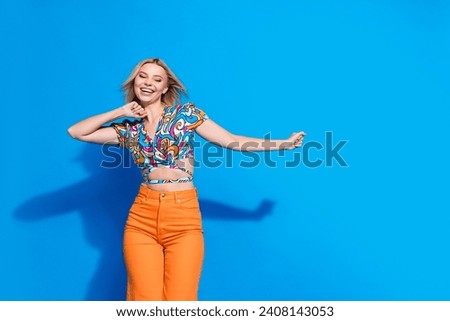 Portrait of cool cheerful person enjoy dancing chilling empty space ad isolated on blue color background