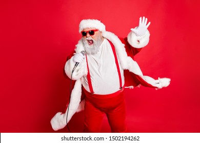 Portrait Of Cool Funny Fat Overweight Santa Claus With Big Belly Sing Song On Christmas Party Wear Style Stylish Trendy Eyeglasses Eyewear Hat Isolated Over Red Background