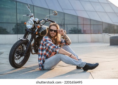 Portrait Of Cool Guy Biker With Sunglasses Sitting On Asphalt.