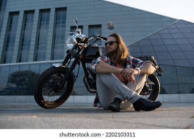 Portrait Of Cool Guy Biker With Sunglasses Sitting On Asphalt.