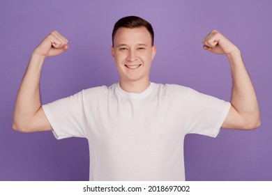 Portrait of cool strong guy raise hands show muscle on violet background - Shutterstock ID 2018697002