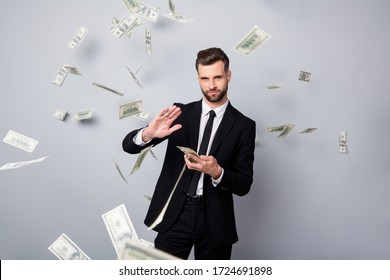 Portrait Of Cool Stunning Rich Wealthy Manager Entrepreneur Company Owner Waste Money Dollars Deposit Flying Falling Air Over Grey Color Background Dressed Black Jacket Pants Blazer Isolated