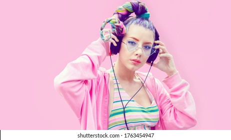 Portrait of cool teenage girl with trendy hairstyle listening music on big headphones – Young fashion woman having fun with technology trends – Stylish gen z teen with crazy hair enjoy modern life - Shutterstock ID 1763454947