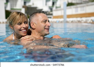 Portrait Of A Couple Bathing In A Swimming Pool