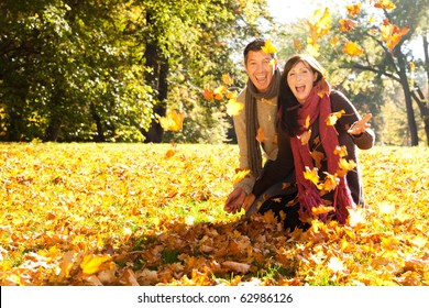 Portrait Of Couple Enjoying Golden Autumn Fall Season