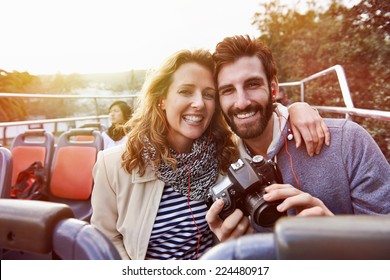 portrait of couple enjoying holiday vacation sightseeing bus open top tour