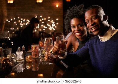 Portrait Of Couple Enjoying Night Out At Cocktail Bar - Powered by Shutterstock