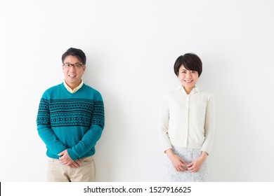 Portrait of couple in front of white wall