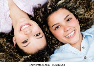 Portrait of a couple of happy twin sisters smiling 
