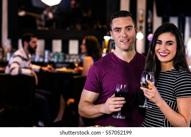 Portrait of couple having a glass of wine in a bar