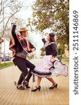 Portrait of a couple of huasos dancing Chilean cueca in the city square