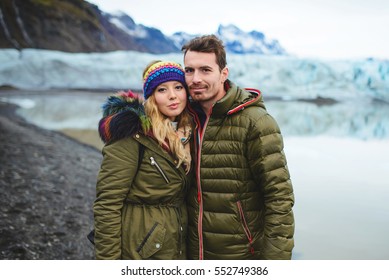 portrait of couple at lake shore and mountains