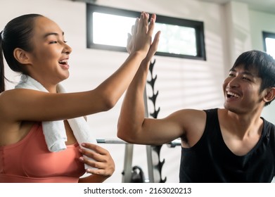 Portrait Of Couple Making Hi Five After Working Out Together