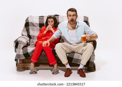 Portrait Of Couple, Man And Woman Watching TV, Movie Together Isolated On White Background. Expressive Emotions. Concept Of Love, Relationship, Retro Style, Creativity, Family. Copy Space For Ad