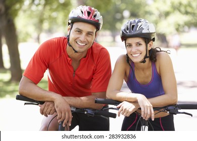 Portrait Of Couple On Cycle Ride Through Park