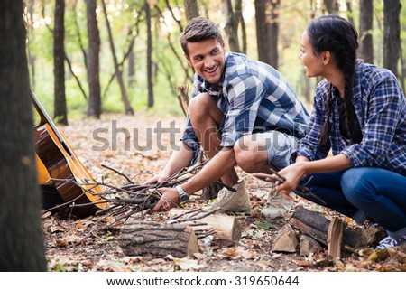 Similar – Man Stoking Fire in a Smoker