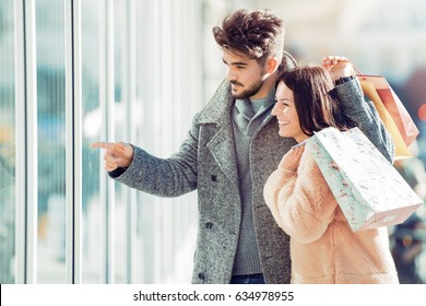 Portrait Of A Couple With Shopping Bags.