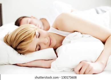 Portrait of couple sleeping in the bed - Powered by Shutterstock