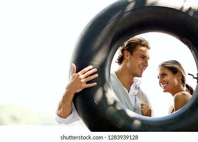 Portrait Of A Couple Through In Inner Tube.