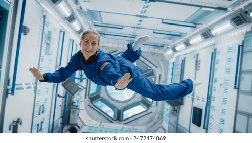 Portrait of a Courageous Caucasian Female Astronaut on Board a Spacecraft, Floating in Zero Gravity and Smiling At The Camera, Waving. Space Travel, Solar System Exploration and Colonization Concept - Powered by Shutterstock