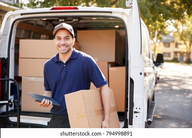 Portrait Of Courier With Digital Tablet Delivering Package - Shutterstock ID 794998891