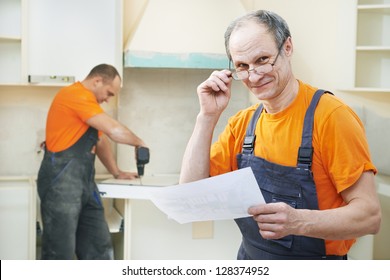 Portrait Of Craftsman Carpenter At Kitchen Cabinet Installation Service Work