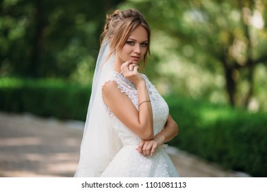 Portrait Of A Crafty Bride Who Conceived Something. A Girl Is Posing In A Lace Wedding Dress. The Blonde Is Getting Married Today.